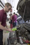 Auto-Lab auto technician Justin Baloh, in foreground, checks the voltage and load on a vehicle's battery as part of preparations for the approaching colder weather. / GILLIS BENEDICT/DAILY PRESS & ARGUS